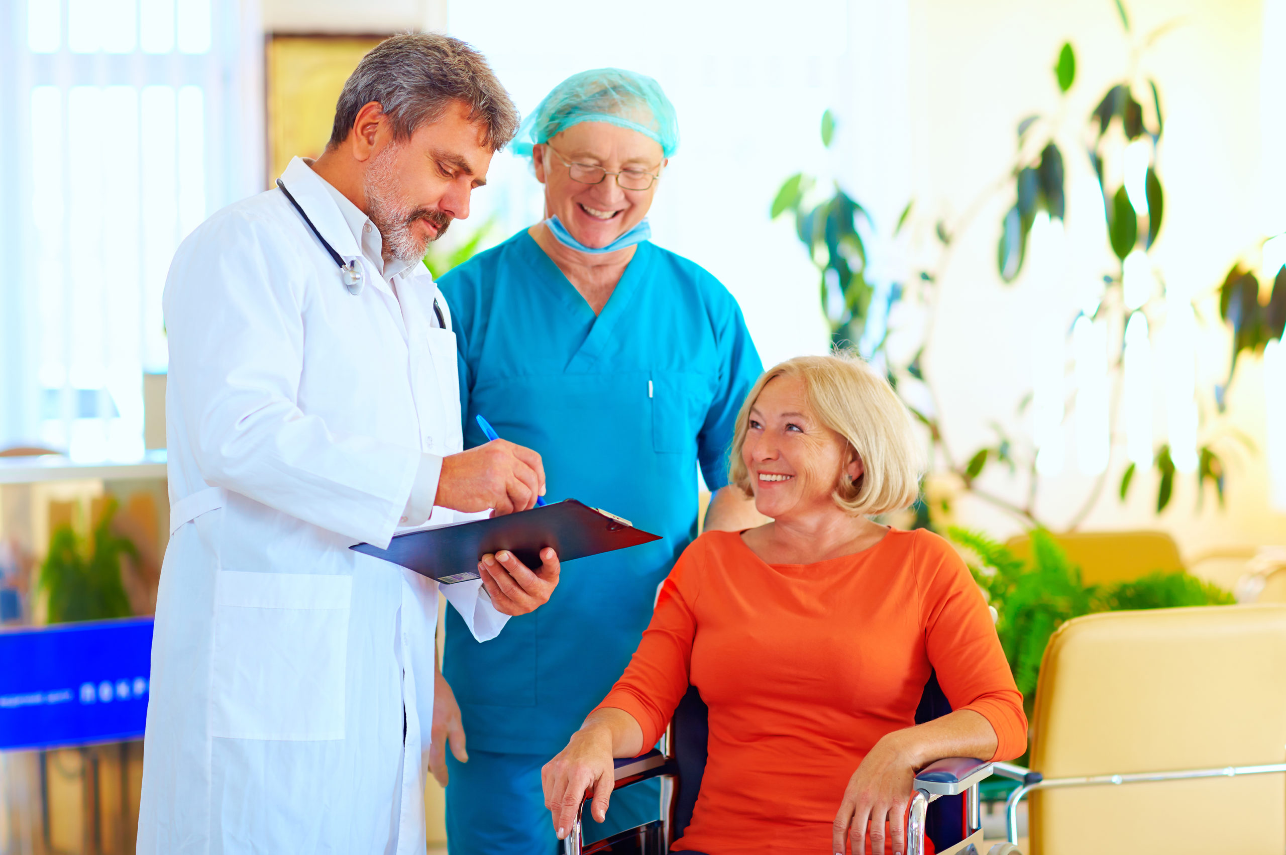 Doctors with a patient in a wheelchair